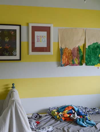 yellow white stripe wall with artwork