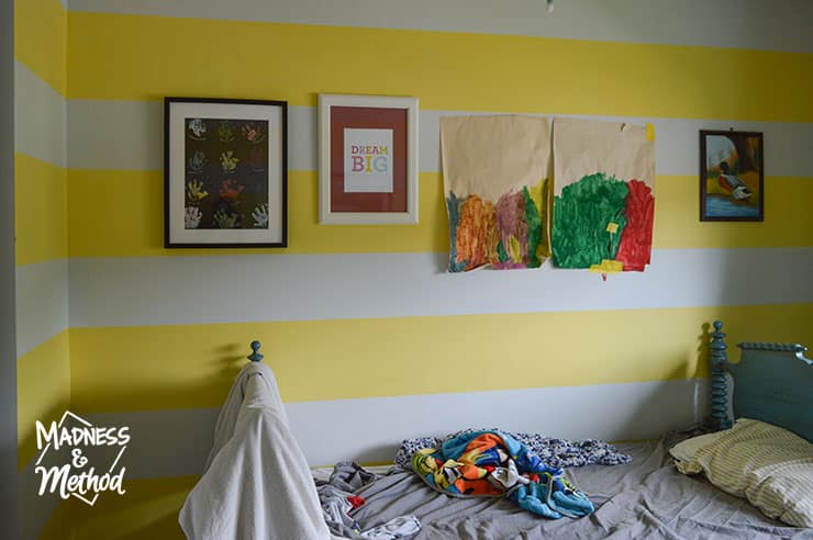 yellow white stripe wall with artwork