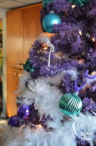 teal christmas decor on purple tree