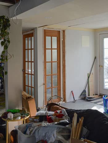 messy basement with glass doors