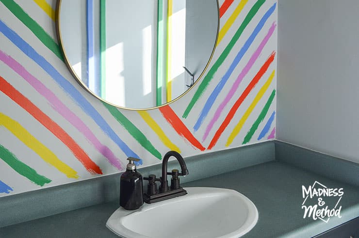 rainbow stripe walls behind mirror