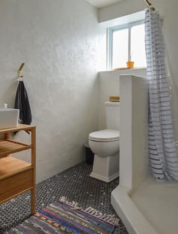 white microcement bathroom with window