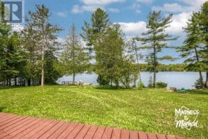 view of grass and water from camp deck