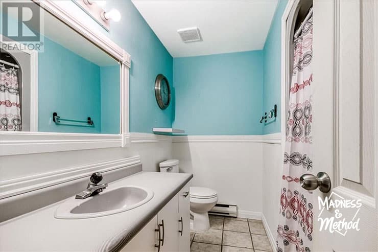 main bathroom with teal and white walls at camp