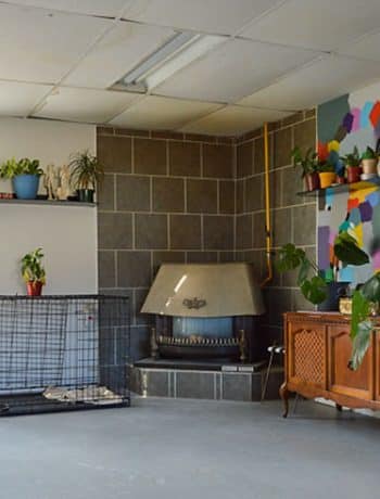 walkout basement with concrete floor and old fireplace