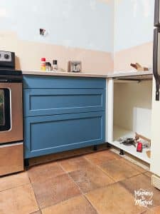 blue ikea cabinet with terracotta floors