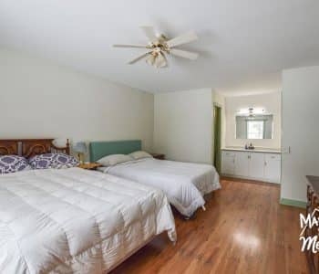 bedroom with two queen beds and open vanity