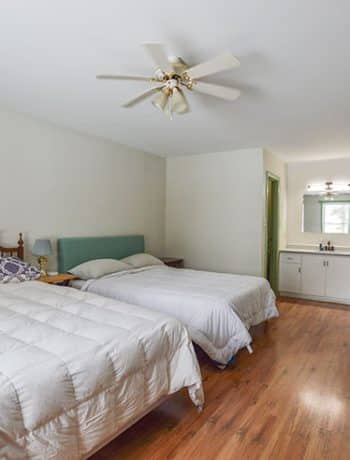 bedroom with two queen beds and open vanity