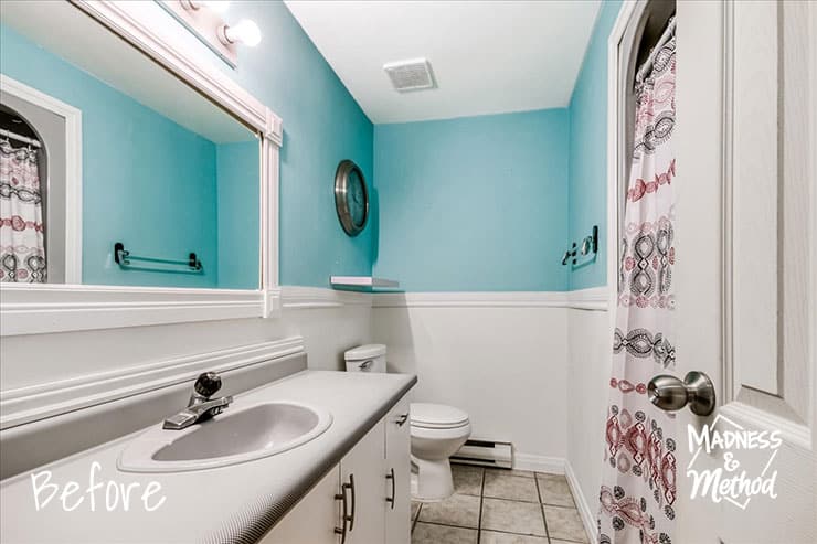bathroom before with teal and white walls