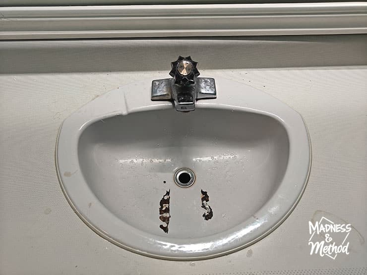 grey damaged sink and grey counters