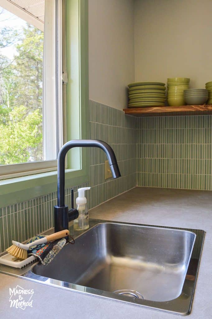 faucet under window in kitchen