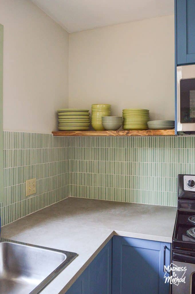 green dinnerware open shelf